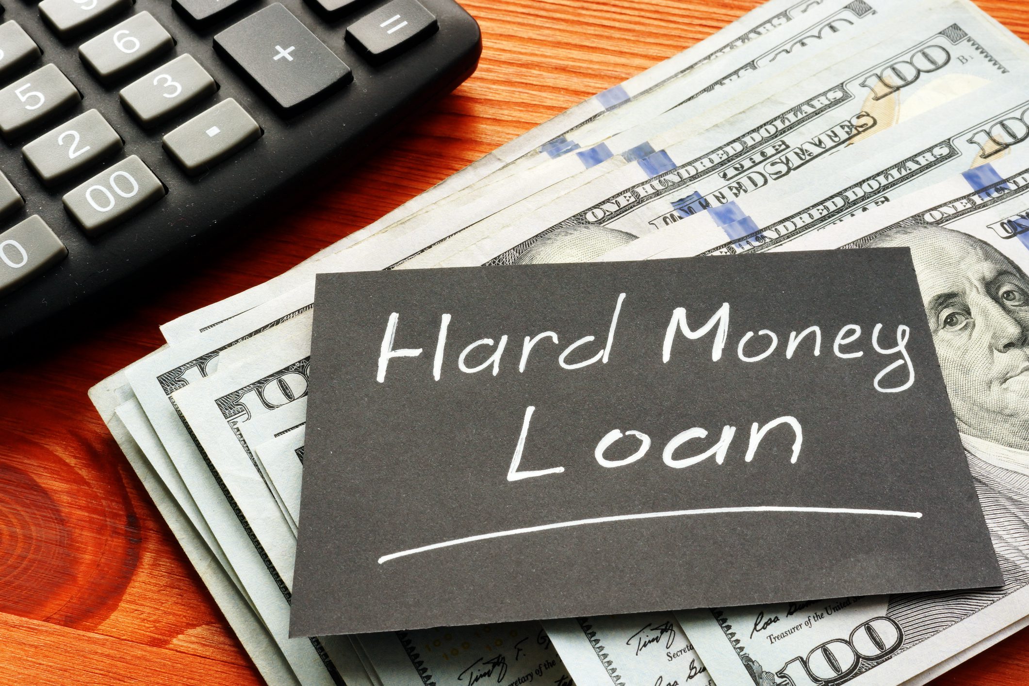 Calculator and cash with hard money loan.